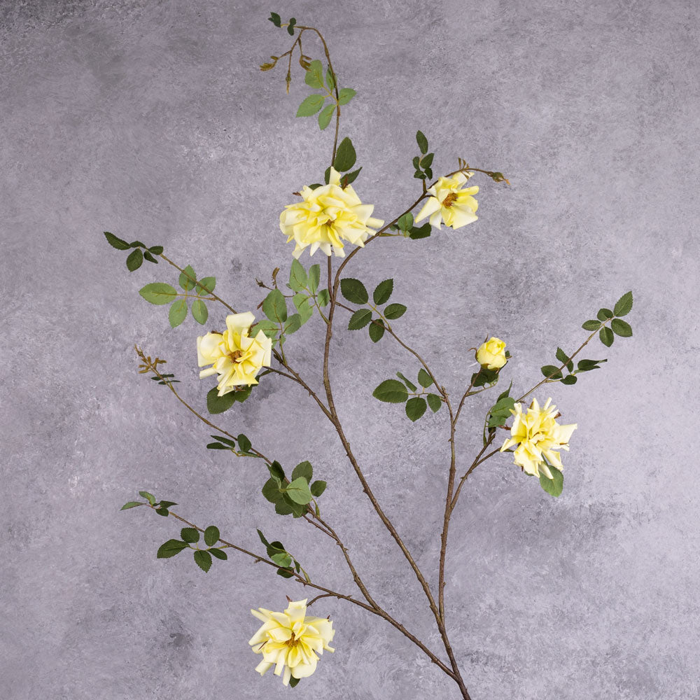 A faux yellow rose spray branch