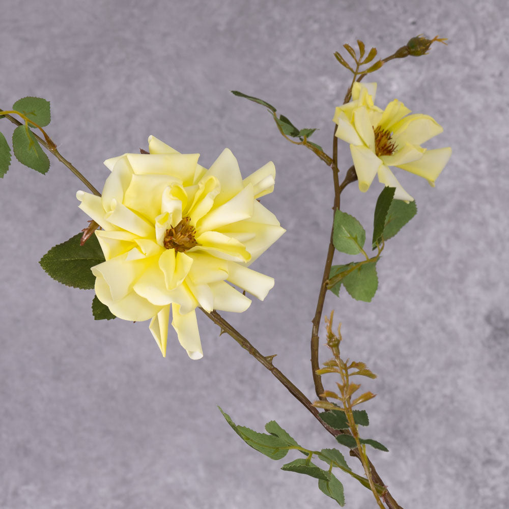 A close up of a faux yellow rose flower