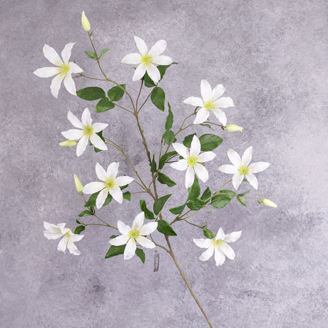 A white, faux clematis spray with lots of flowers and leaves over a number of branchlets