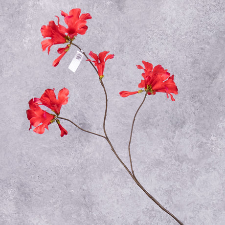 A single, faux mandevilla spray with several red flowers