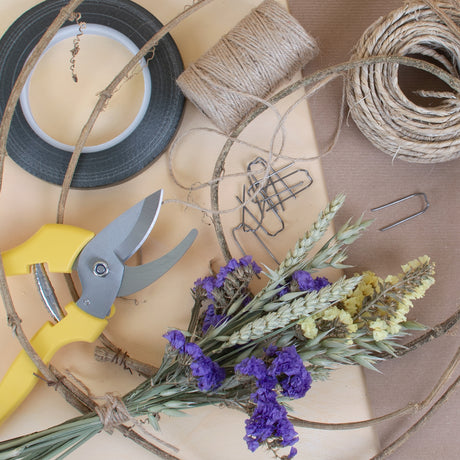 A selection of floristry tools on a bench