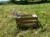 Faux pink and white gypsophila in a wooden crate, displayed outside on a bright sunny day!