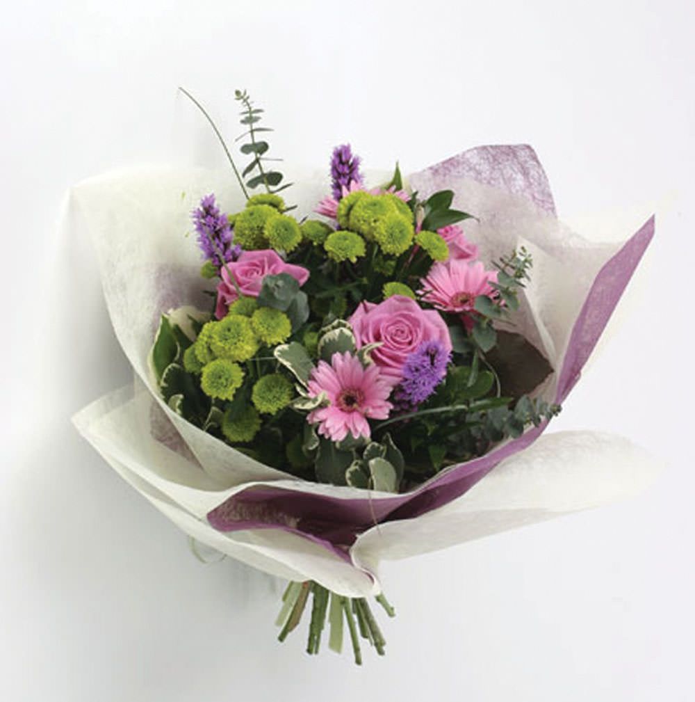 This image shows a bouquet of flowers wrapped in the spiders web material.