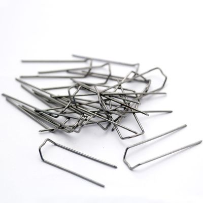 This image shows some mossing pins scattered on a white background.