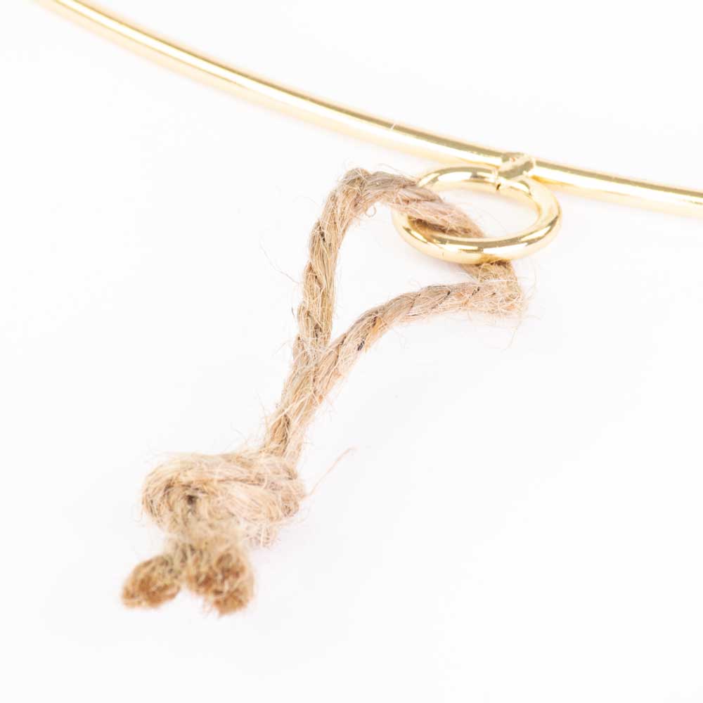 a single gold coloured wreath ring with hanging loop, against a white background