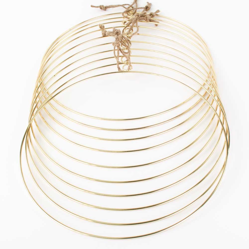 a set of 10 gold coloured wreath rings with hanging loop, against a white background