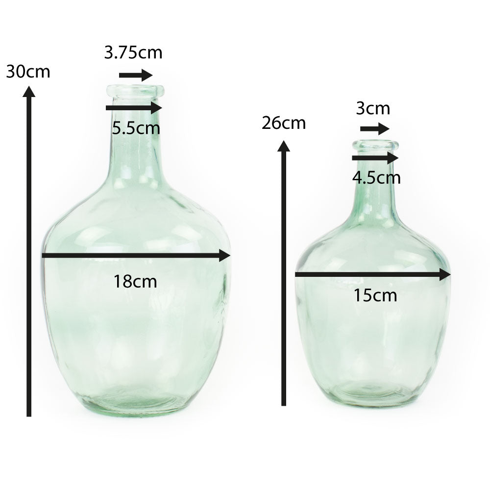 a pair of light green glass bottle vases