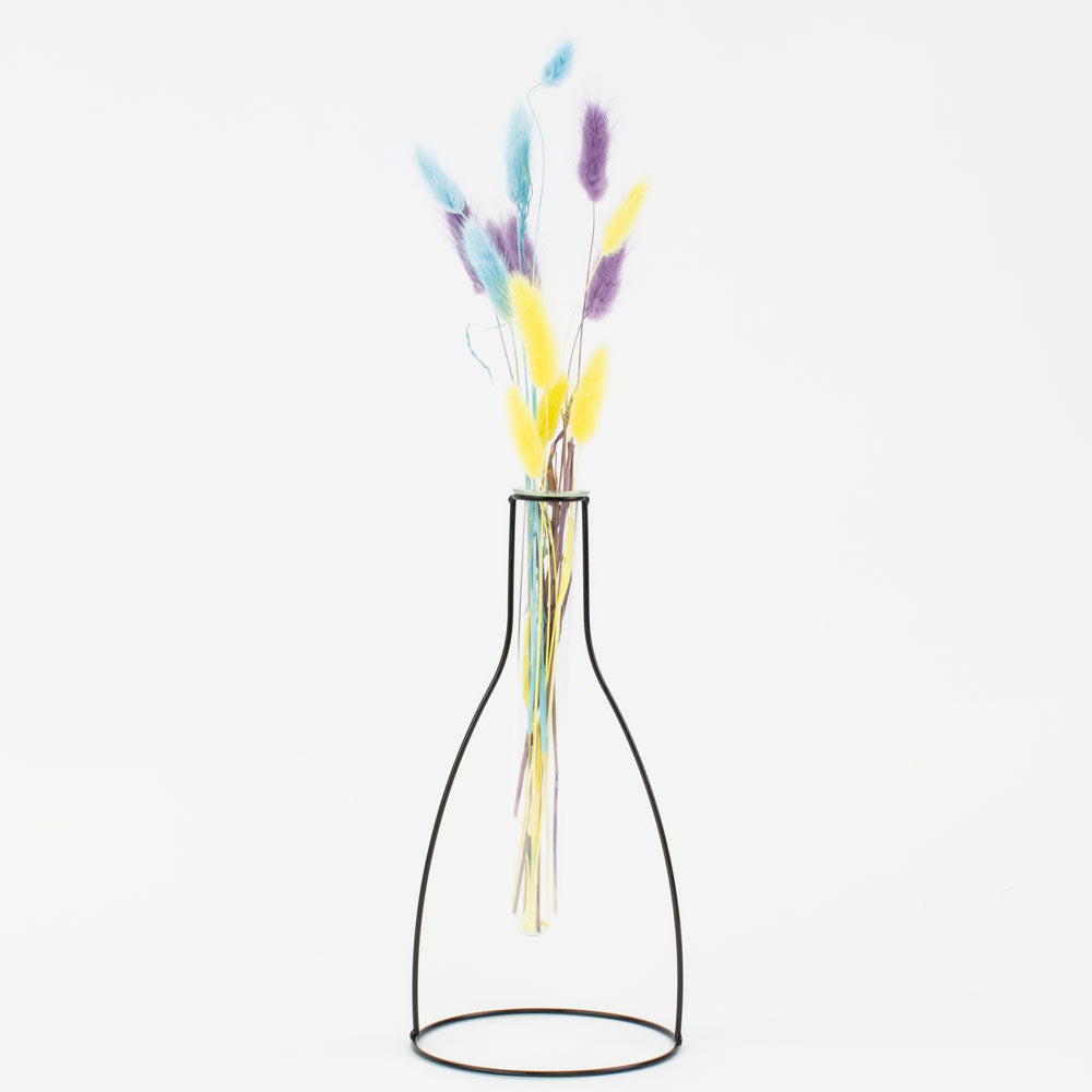 a metal framed, shaped outline of a vase that contains a glass test tube, in which to place flowers