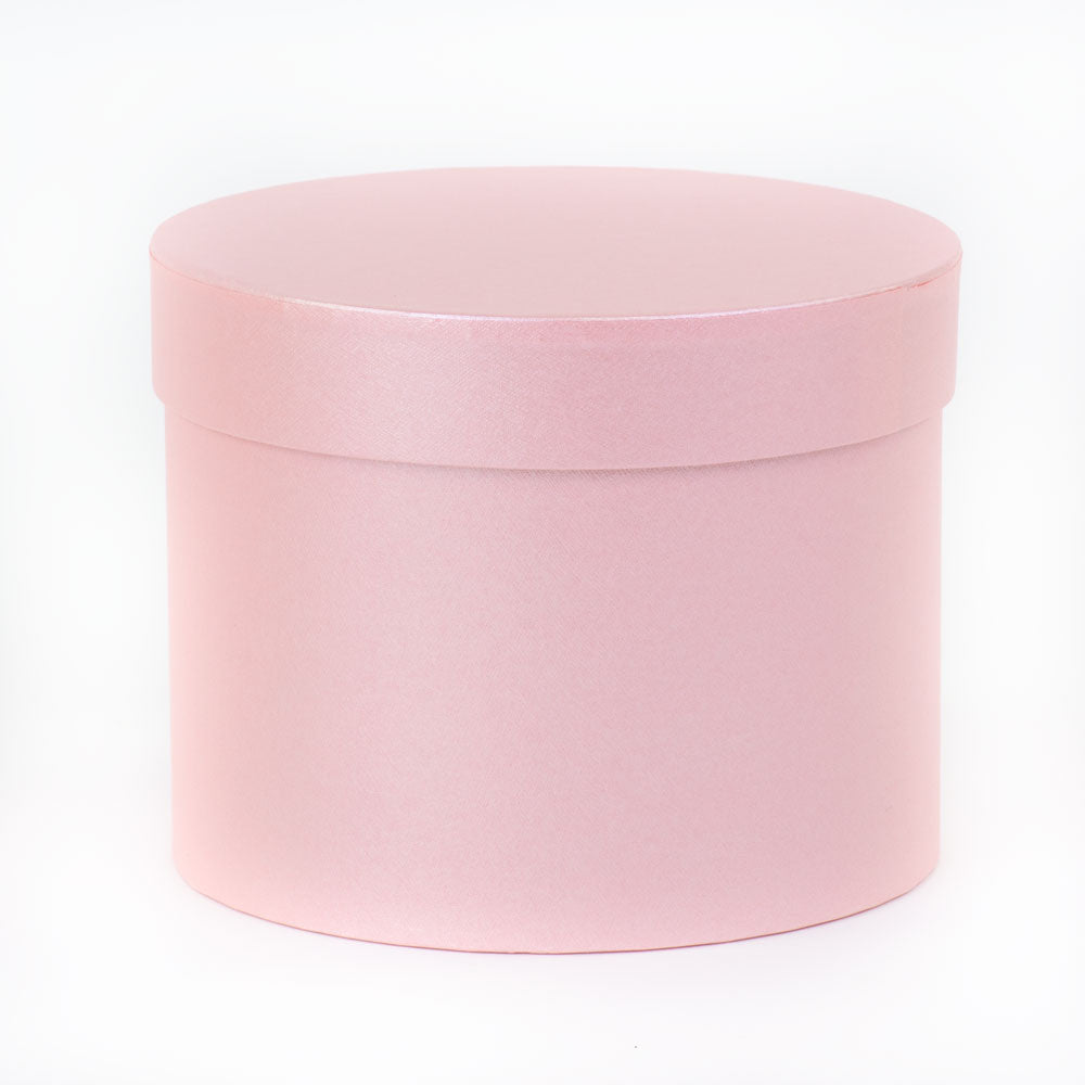 a pale pink hat box with lid