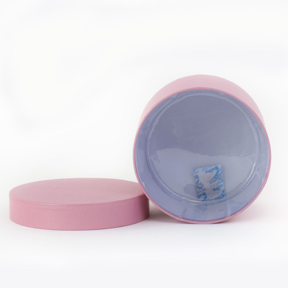 a baby pink coloured hat box