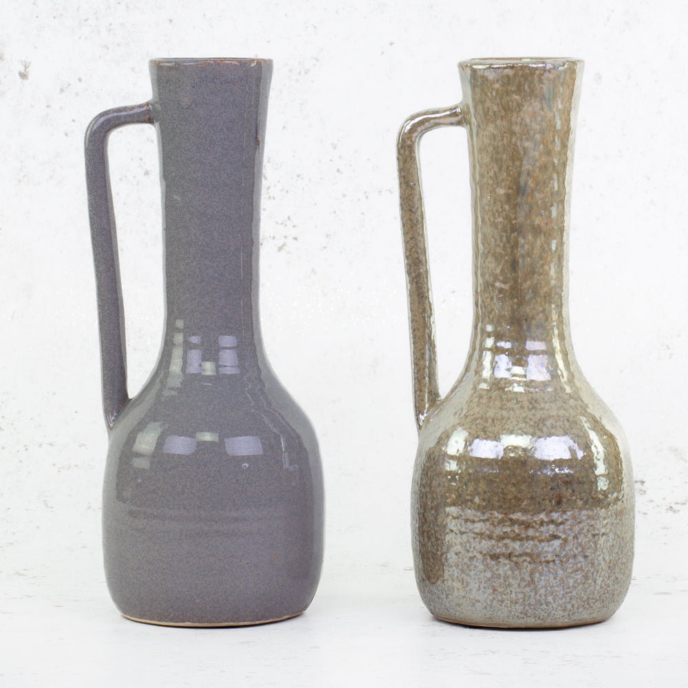 A pair of pearlescent tall vases in two different colours