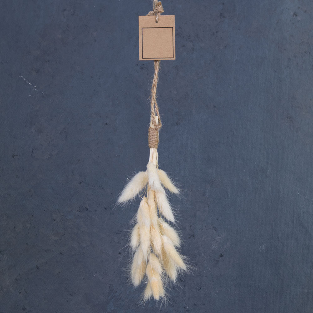 A close up of a bleached White lagurus formed into a little hanging decoration.