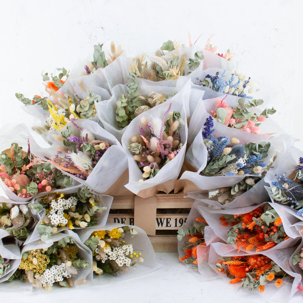 A display of lots of dried flower bouquets.