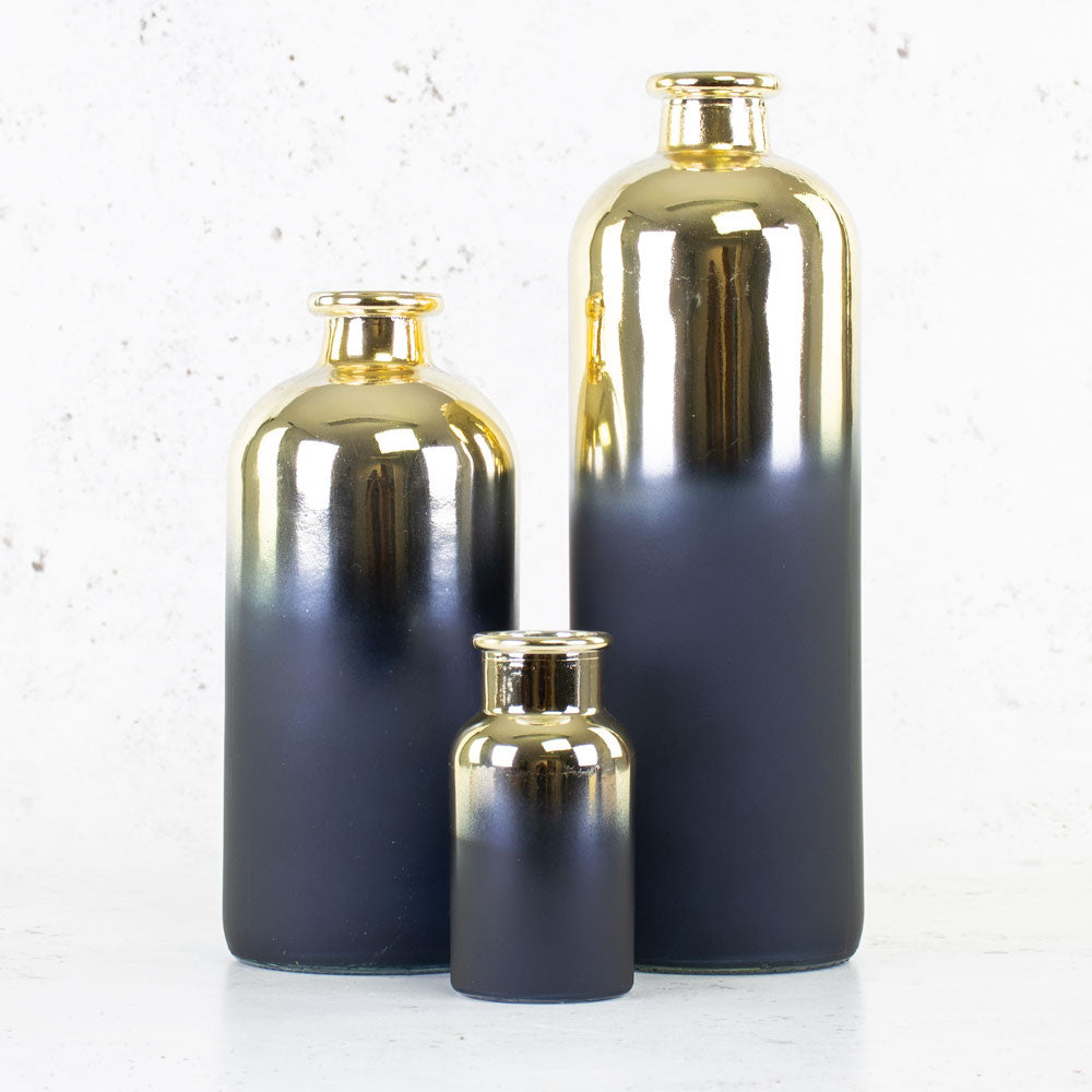 Trio of indigo and gold bottle vases in different sizes