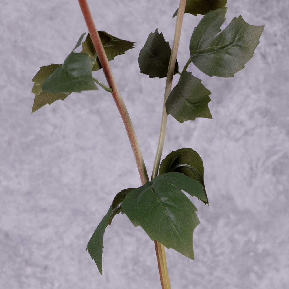A close up of the foliage on a faux dahlia spray