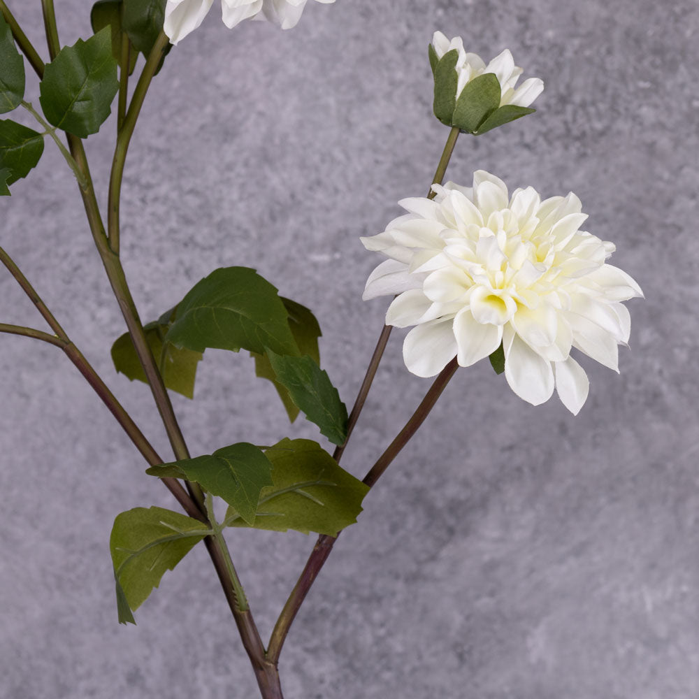 A close up of a white, faux dahlia flower
