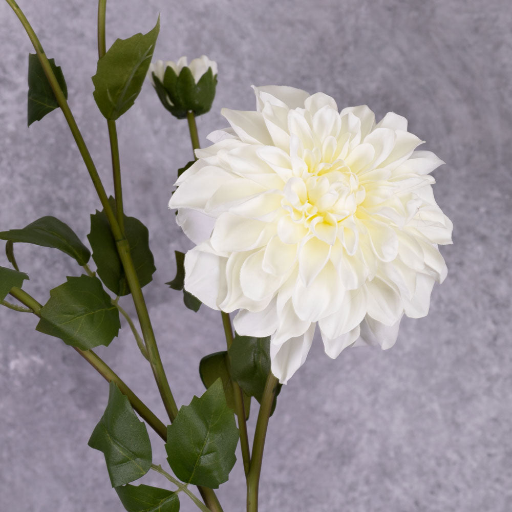 A close up of a white, faux dahlia flower
