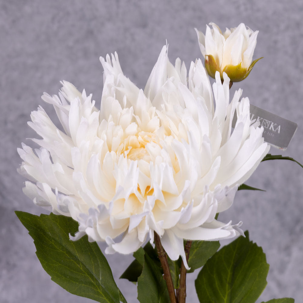A close up of a faux chrysanthemum spray with off-white flower and emerging bud
