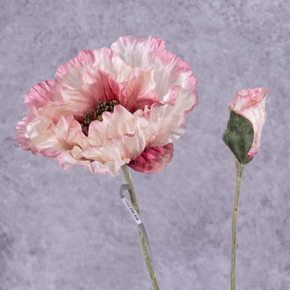 A faux poppy stem with an open flower and a budding flower on two branchlets. The flowers are a pale pink with a white gradient towards the centre