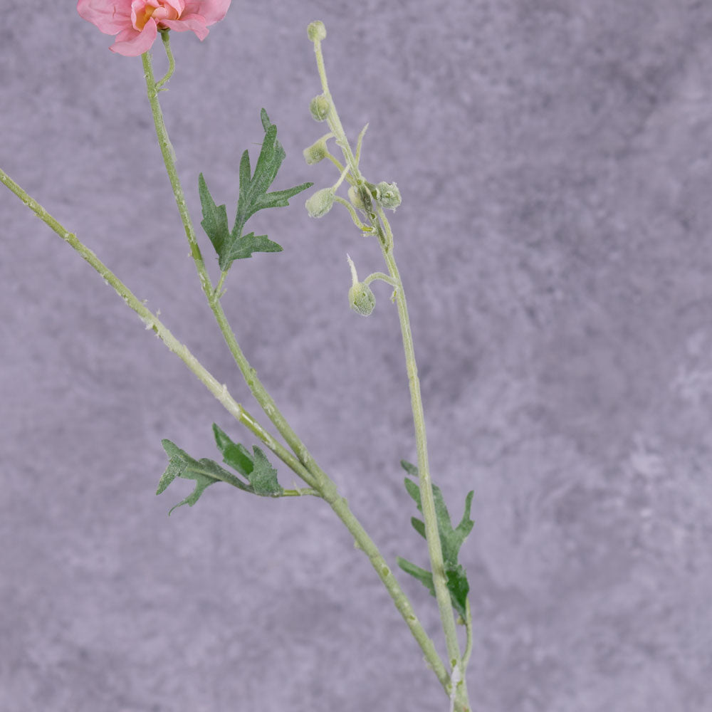 A close up of a faux delphinium stem showing the flocked surface and three sets of leaves