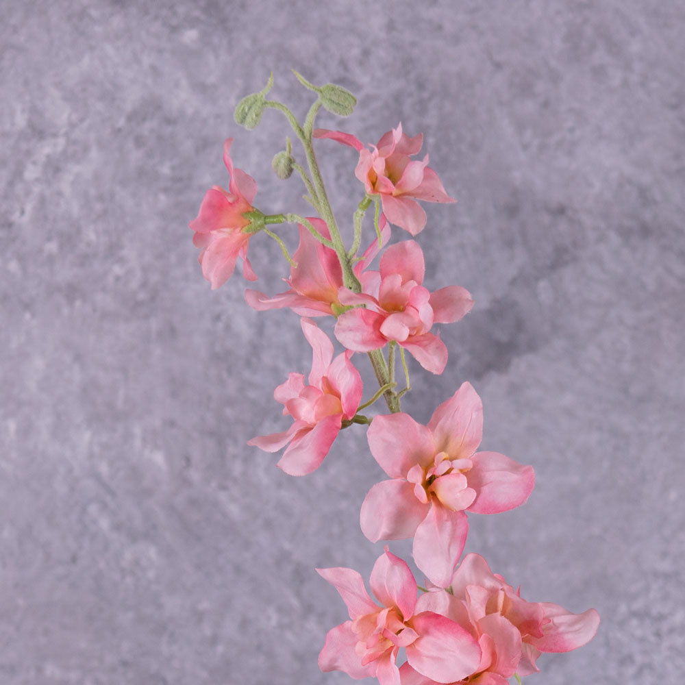 A close up of a faux delphinium with pink flowers