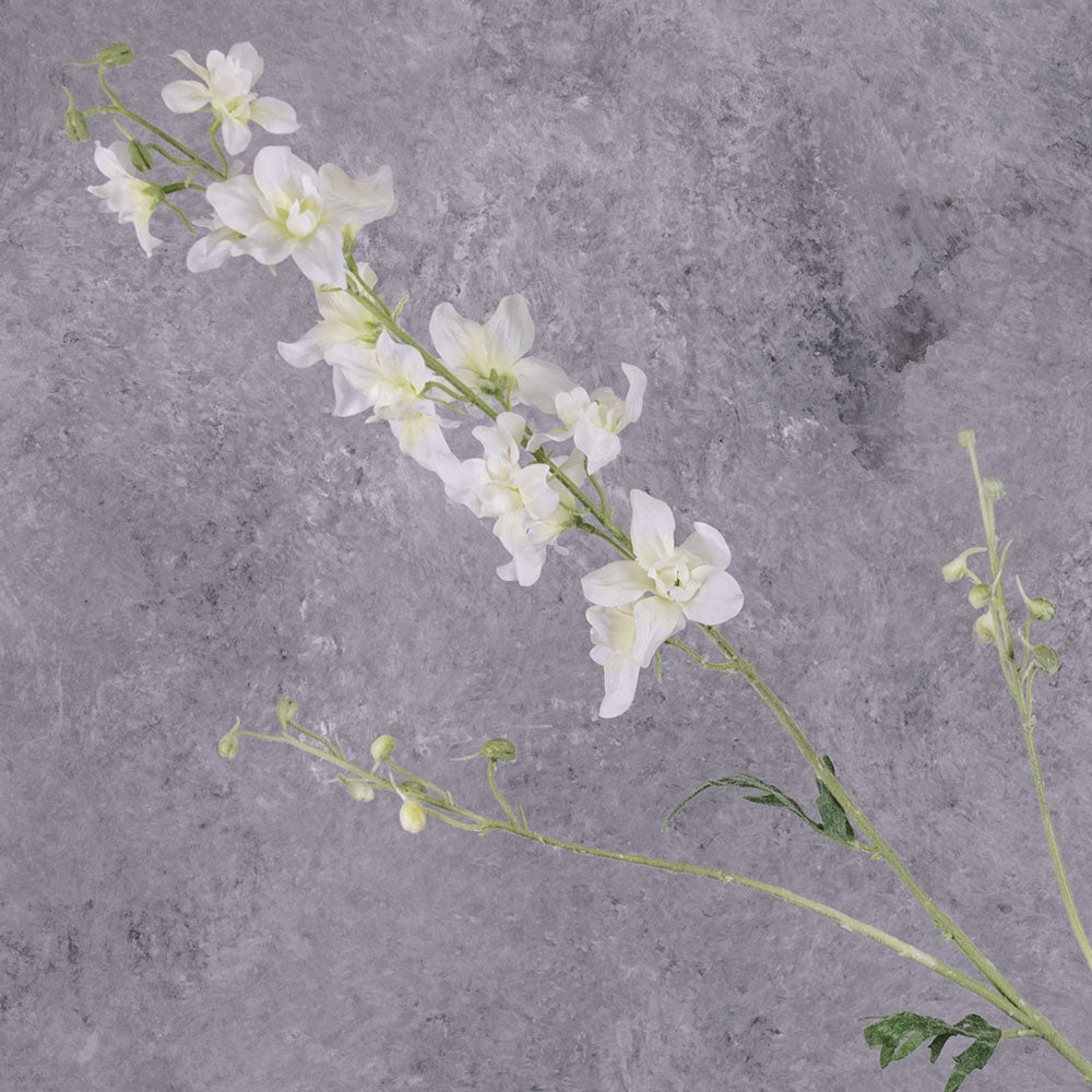 A tall faux delphinium with white flowers