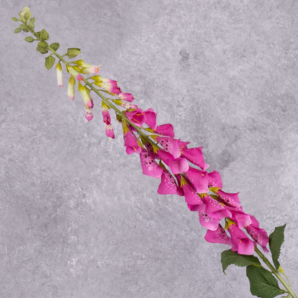 A single fuchsia coloured faux foxglove stem