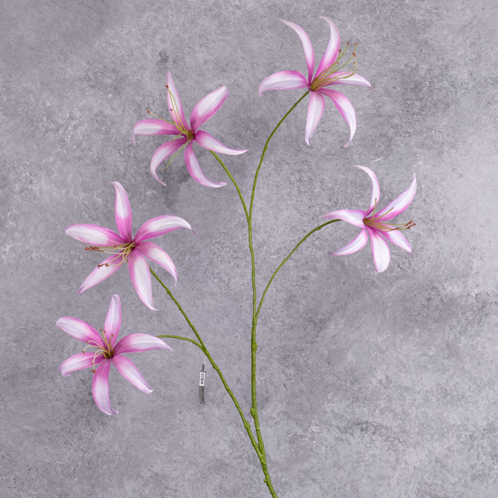 A tall. faux lily spray with light pink flowers that have darker pink edges to the petals